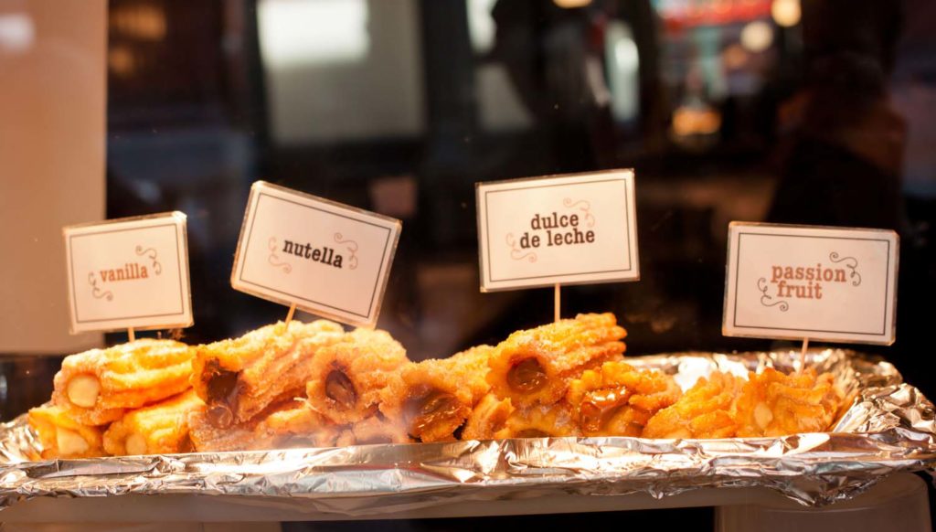 Image of filled churros in a window display 